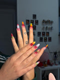 Handmade press-on nails with airbrush in red, green, blue, and yellow./ Faux ongles "press-on" faits main avec dégradé à l'airbrush en rouge, vert, bleu et jaune.