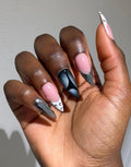 Handmade press-on nail in black, white, and silver chrome.